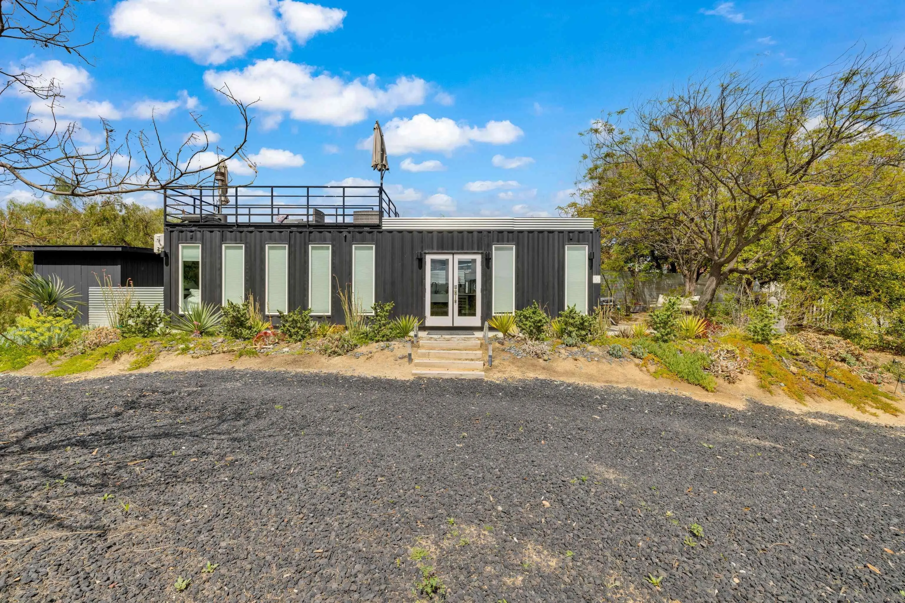 37389 Ave Chapala Temecula, CA 92592 - Photo 61 of 68 a front view of a house with a yard and lake view