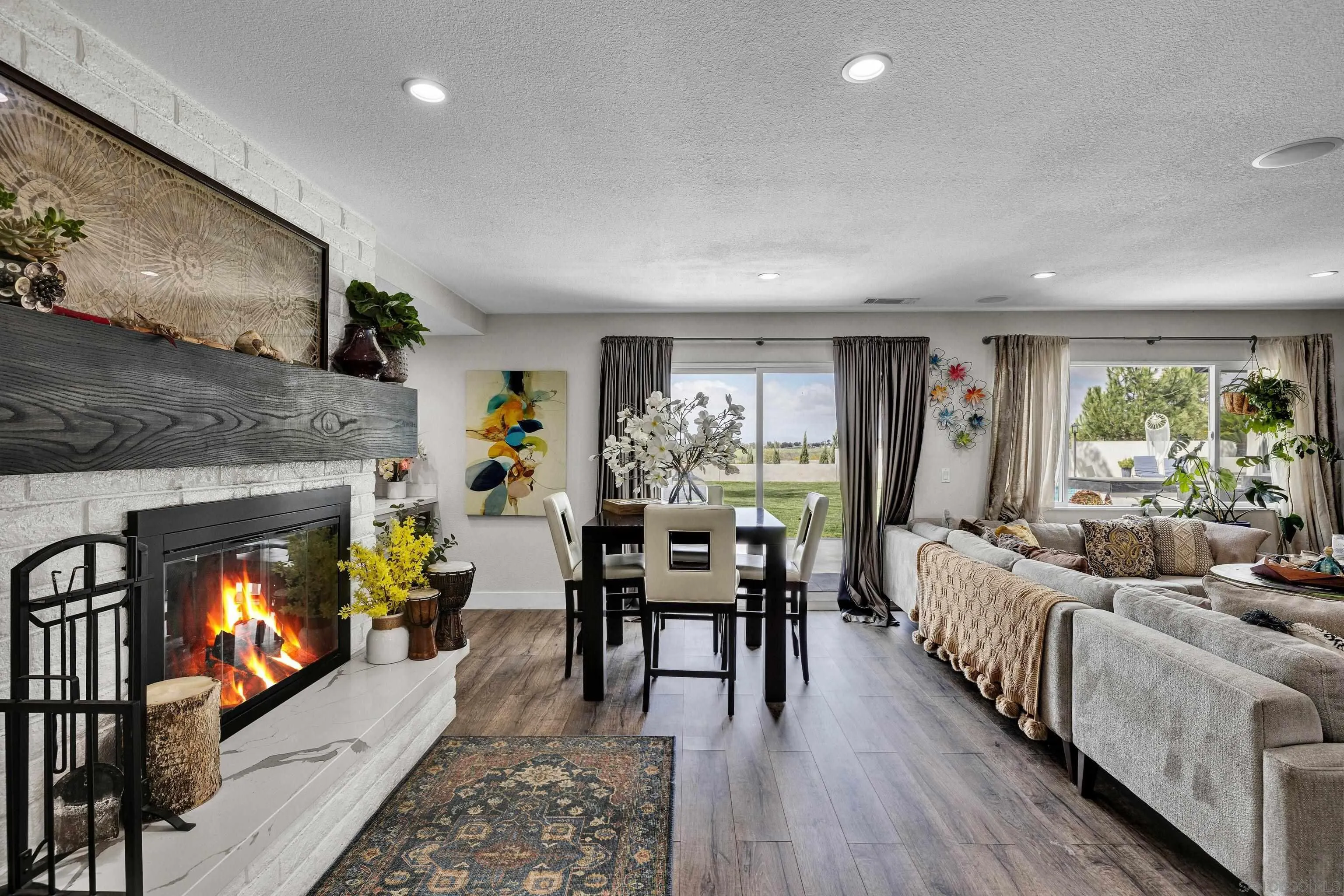 37389 Ave Chapala Temecula, CA 92592 - Photo 7 of 68 a living room with furniture a flat screen tv and a fireplace