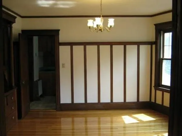a view of a porch with wooden floor and chandelier