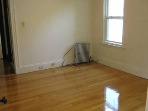 wooden floor and window in an empty room