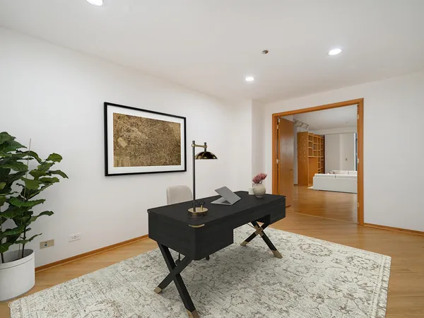 a living room with a table and a potted plant
