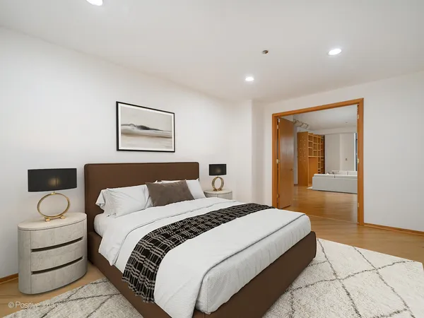 a spacious bedroom with a bed and a view of bathroom