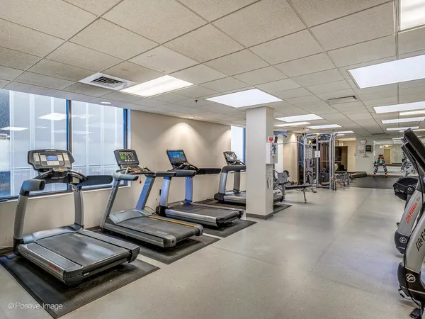 a room with gym equipment and a large window