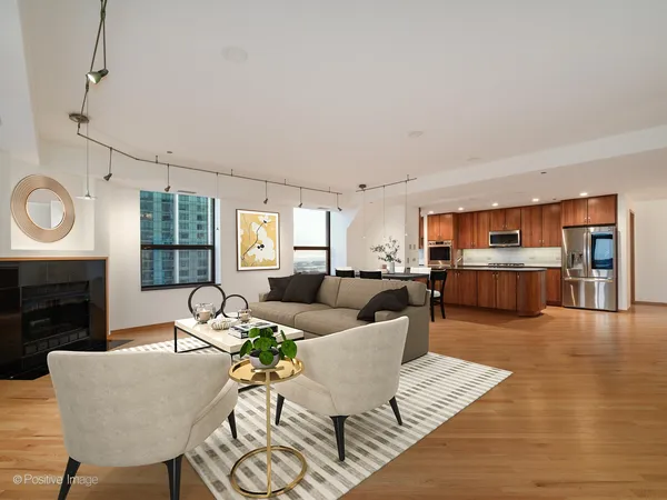 a living room with furniture kitchen view and a fireplace