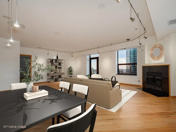 a living room with furniture a fireplace and kitchen view