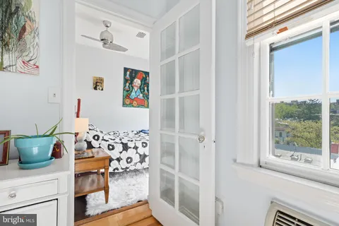 a bedroom with a bed and a painting on the wall
