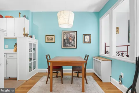 a view of a dining room with furniture and a chandelier