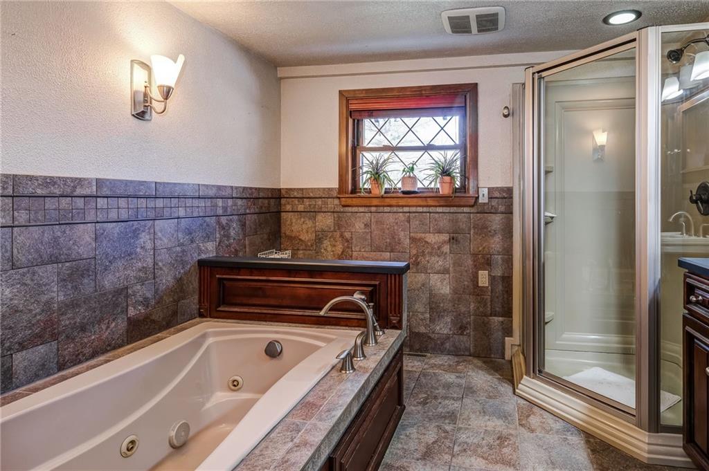885 Black Road Volant, PA 16156 - Photo 11 of 24 a bathroom with a bathtub and a shower