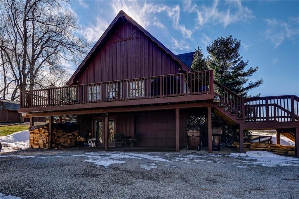 885 Black Road Volant, PA 16156 - Photo 19 of 24 a view of a house with wooden deck and a floor to ceiling window