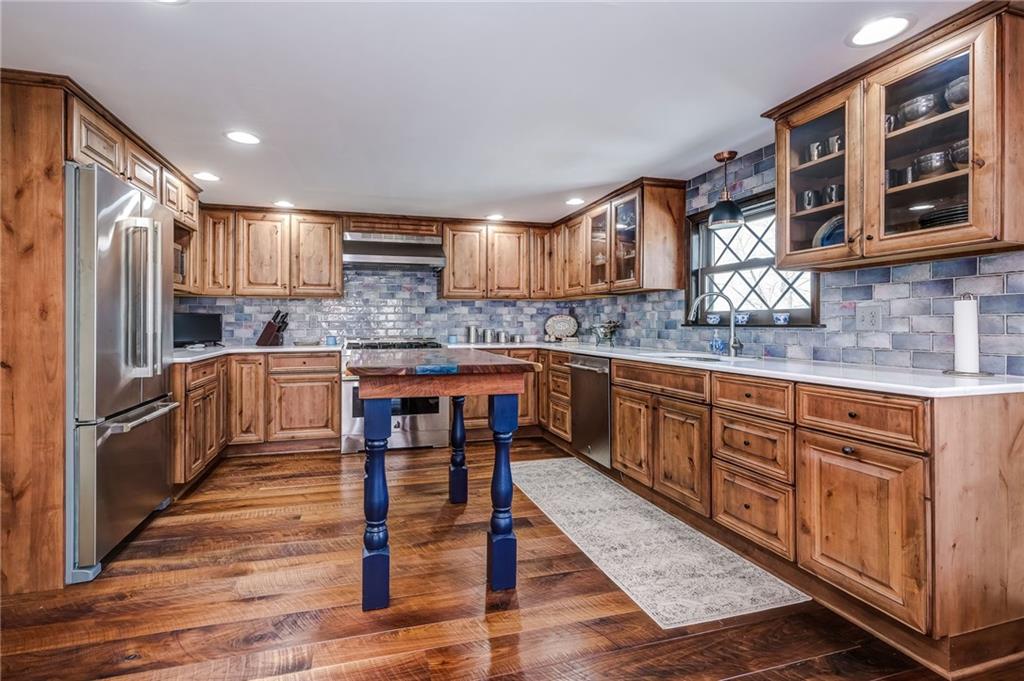 885 Black Road Volant, PA 16156 - Photo 6 of 24 a kitchen with stainless steel appliances granite countertop wooden cabinets and a refrigerator