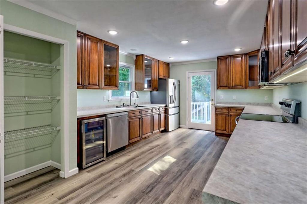 28 Coon Tail Road Blairsville, GA 30512 - Photo 33 of 100 a kitchen with stainless steel appliances kitchen island granite countertop a stove a sink and a refrigerator