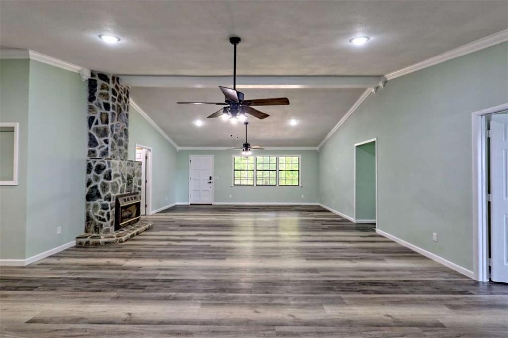28 Coon Tail Road Blairsville, GA 30512 - Photo 44 of 100 a view of an empty room with wooden floor ceiling fan and windows