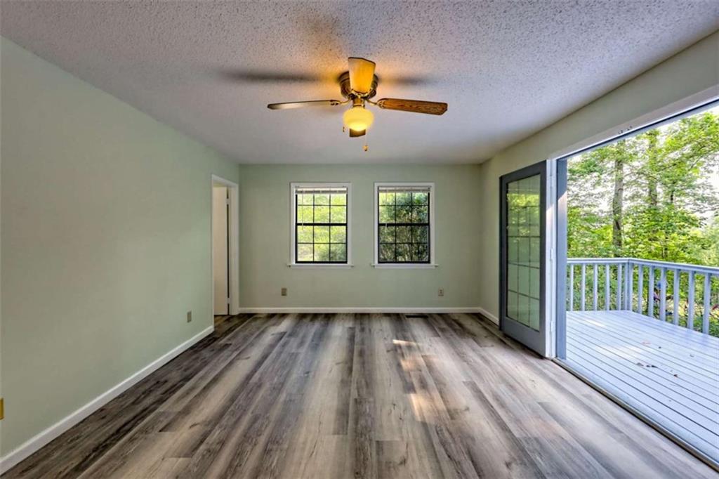 28 Coon Tail Road Blairsville, GA 30512 - Photo 50 of 100 a view of an empty room with wooden floor and a window