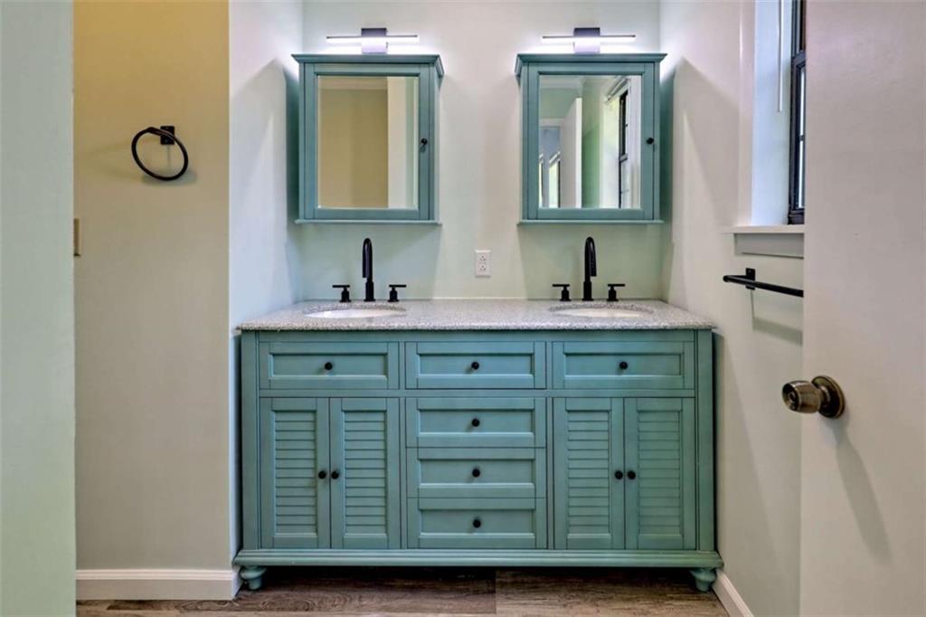 28 Coon Tail Road Blairsville, GA 30512 - Photo 56 of 100 a bathroom with a granite countertop sink vanity and mirror