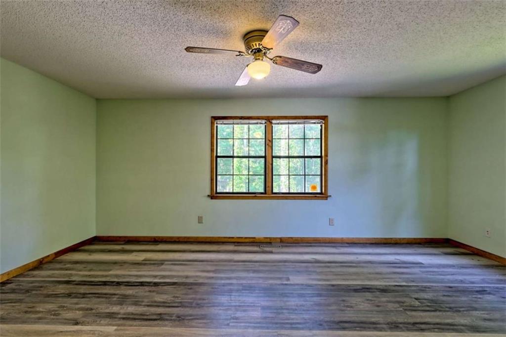 28 Coon Tail Road Blairsville, GA 30512 - Photo 65 of 100 a view of a room with wooden floor and a ceiling fan