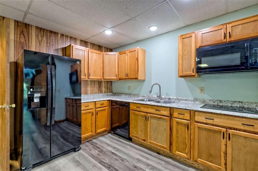 28 Coon Tail Road Blairsville, GA 30512 - Photo 88 of 100 a kitchen with stainless steel appliances granite countertop a refrigerator a sink and a stove