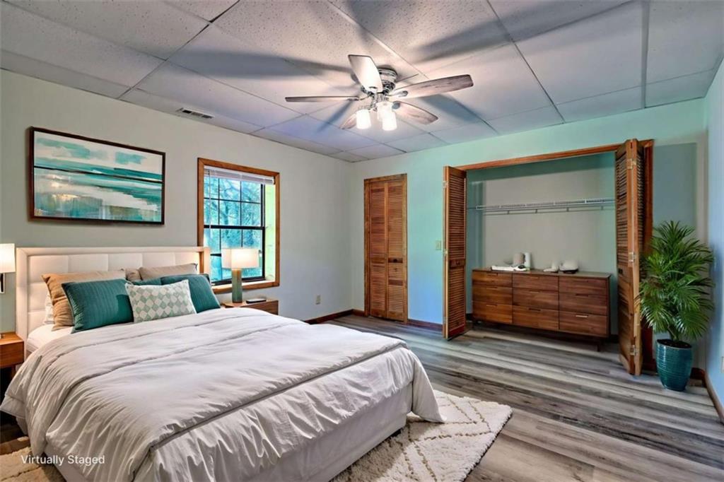 28 Coon Tail Road Blairsville, GA 30512 - Photo 93 of 100 a bedroom with a large bed and a chandelier fan