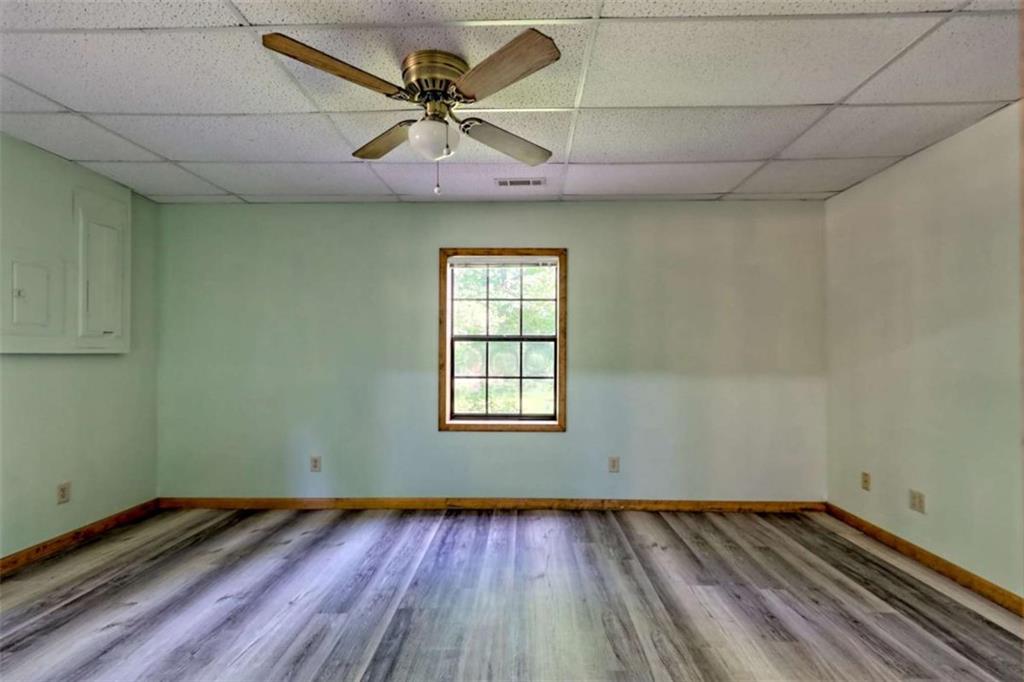28 Coon Tail Road Blairsville, GA 30512 - Photo 98 of 100 a view of a room with wooden floors and ceiling fan