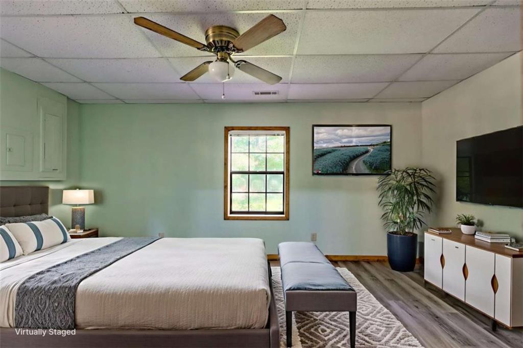 28 Coon Tail Road Blairsville, GA 30512 - Photo 99 of 100 a bedroom with a large bed and a flat screen tv