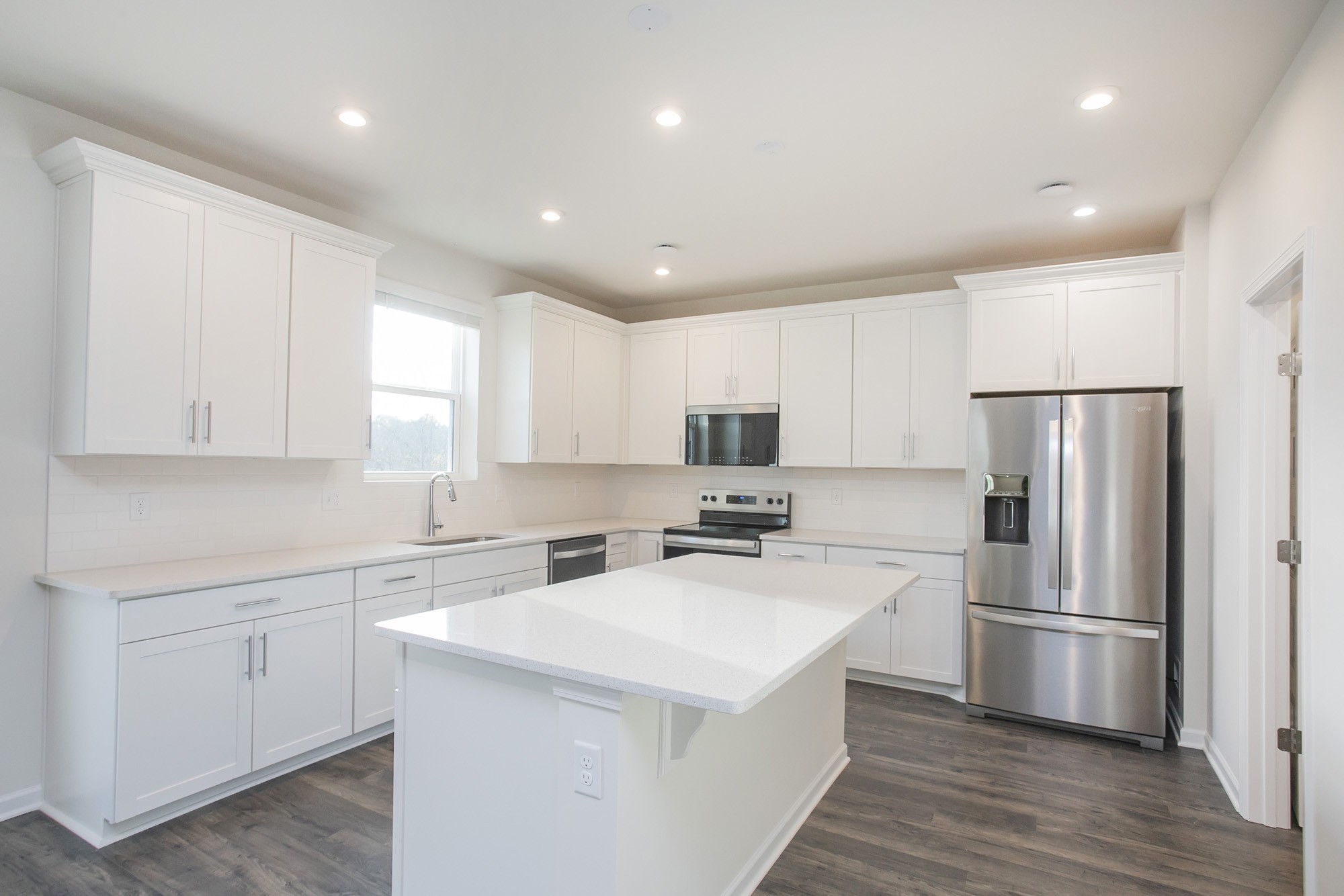 1304 Godwin Road Hermitage, TN 37076 - Photo 13 of 28 a kitchen with a refrigerator a sink and white cabinets