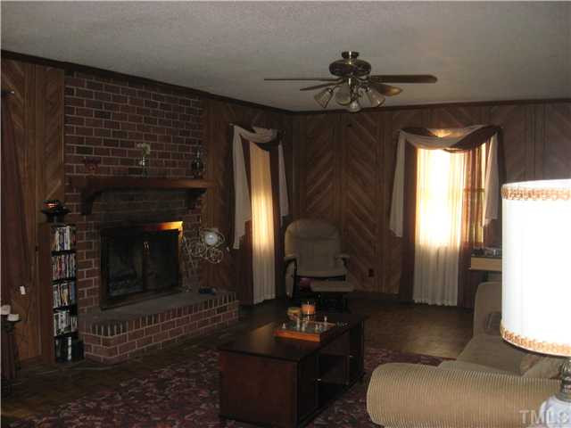 524 Dacian Road Raleigh, NC 27610 - Photo 3 of 5 a living room with furniture and a fireplace