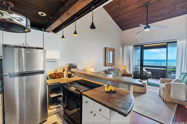 a kitchen with a sink appliances and cabinets