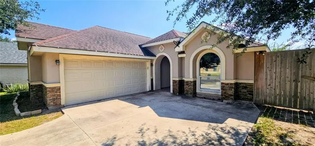 a view of entrance gate of house and wooden deck