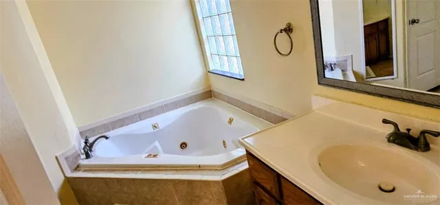 a bathroom with a tub and a sink