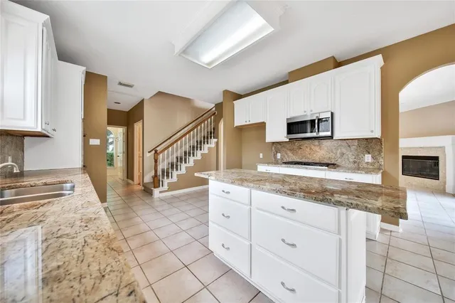 a bathroom with a granite countertop sink and mirror
