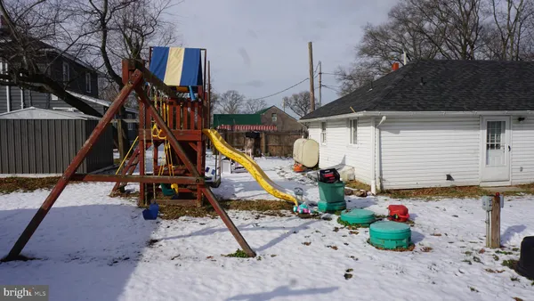 a view of a house with wooden fence