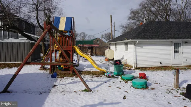 a view of a house with wooden fence