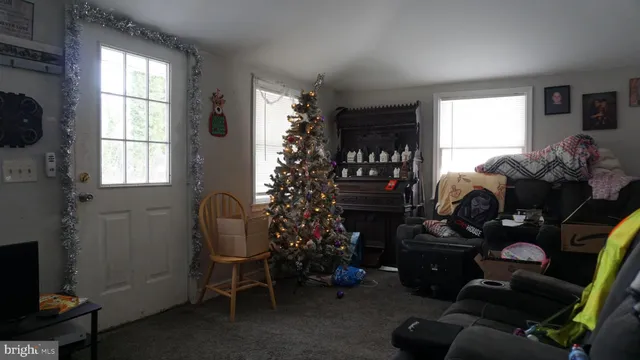 a room with furniture a rug and a window