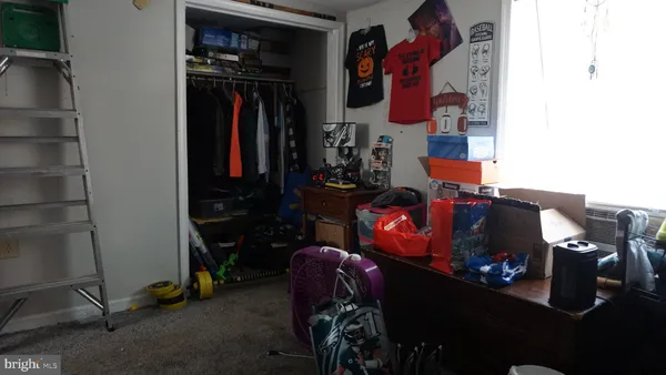 a bedroom with a bed a flat screen tv and dresser