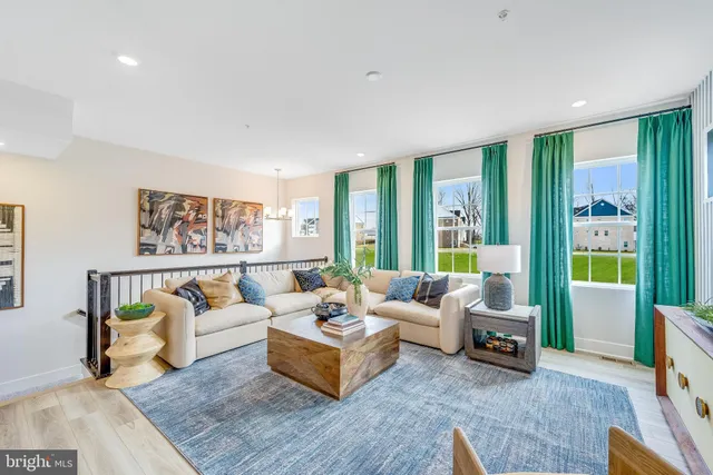 a living room with furniture and large windows