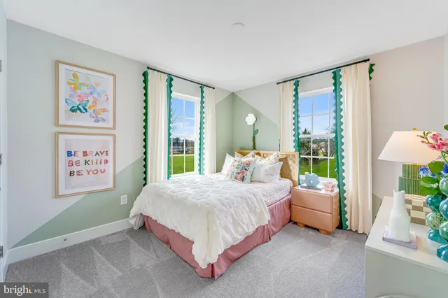 a bed room with a bed and a painting on the wall