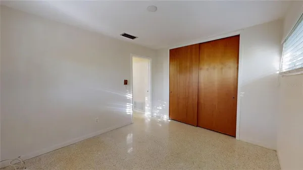a kitchen with a sink a window and cabinets