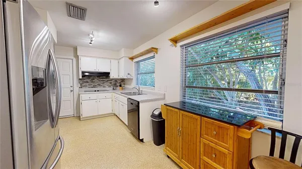 a kitchen with stainless steel appliances granite countertop a sink and a window