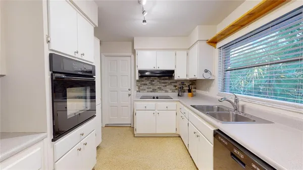 a kitchen with a sink and a window