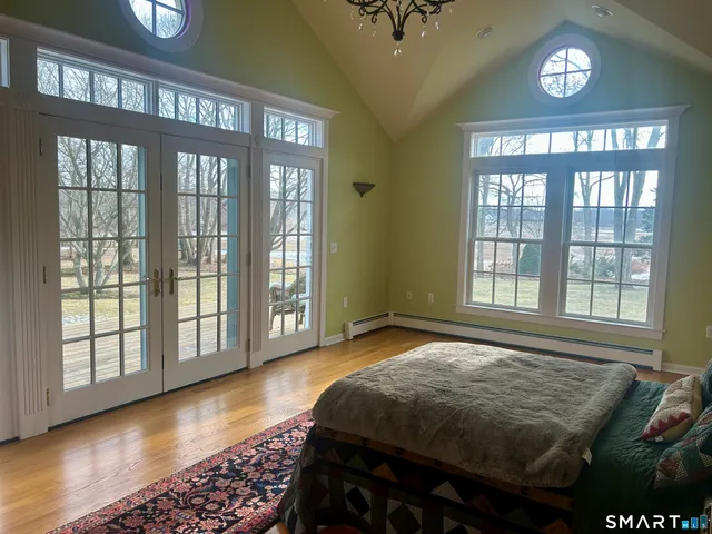 a bedroom with a bed and a large window