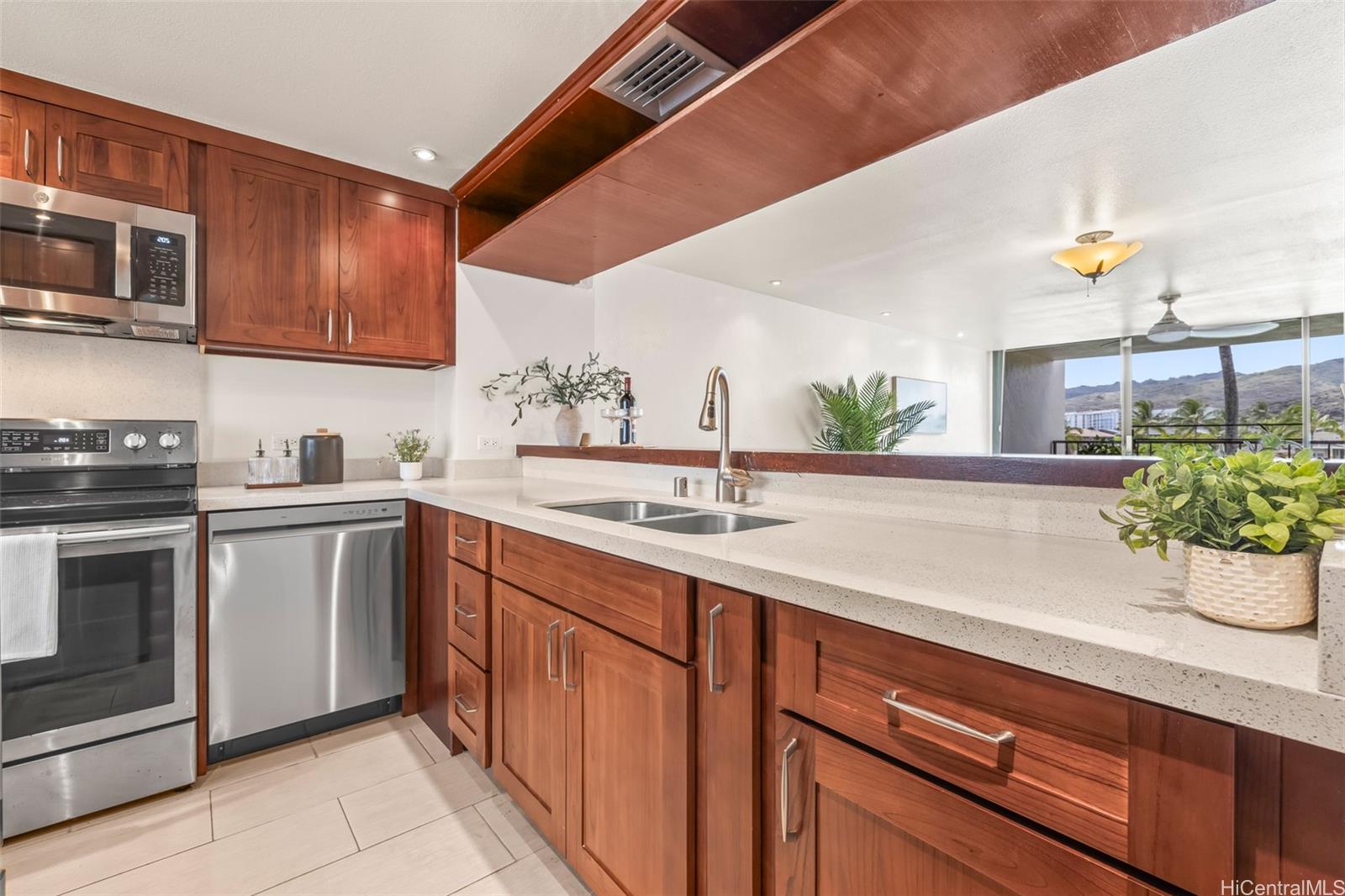 500 Lunalilo Home Road, Unit 22C Honolulu, HI 96825 - Photo 2 of 25 Beautiful rich wood grain cabinets and quartz countertops.