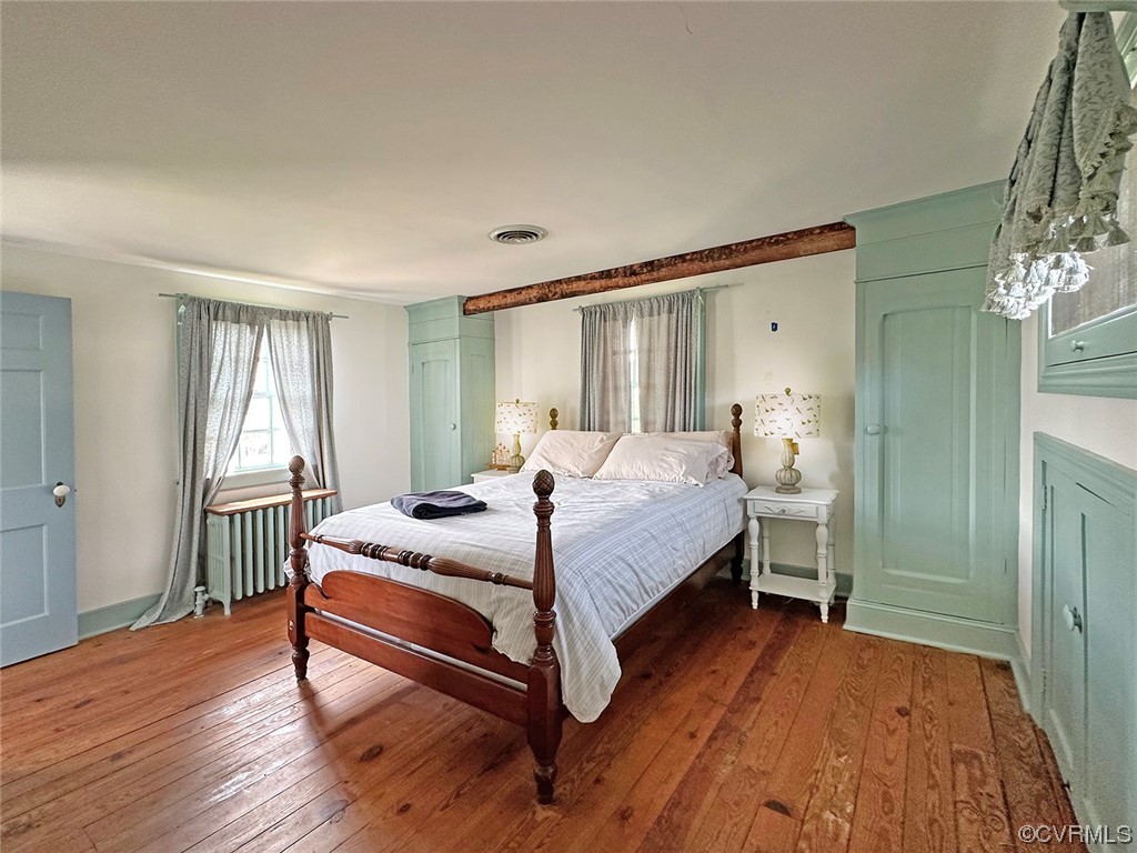 616 Main Street Reedville, VA 22539 - Photo 21 of 30 a bedroom with a bed and a mirror