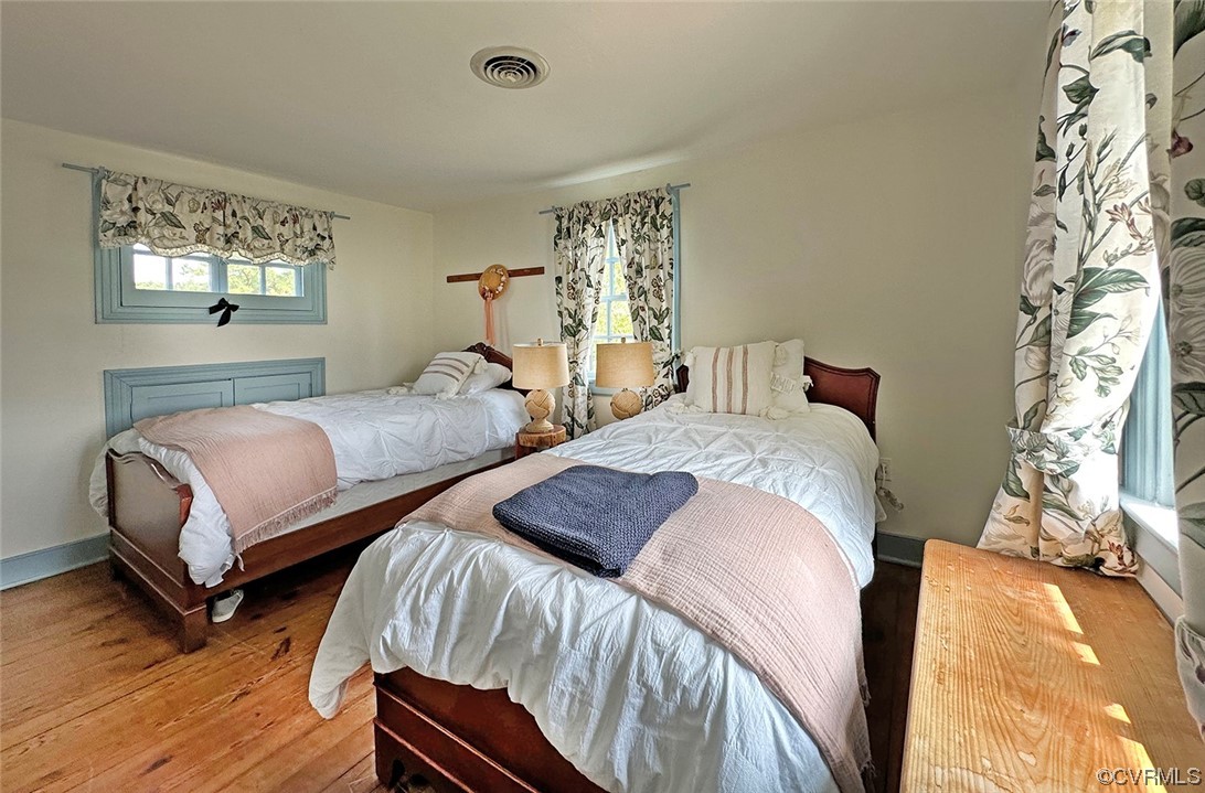 616 Main Street Reedville, VA 22539 - Photo 22 of 30 a bedroom with two beds and a chandelier