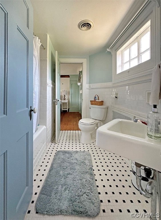 616 Main Street Reedville, VA 22539 - Photo 24 of 30 a spacious bathroom with a double vanity sink toilet and shower