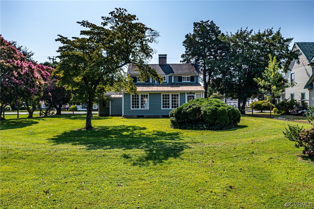 616 Main Street Reedville, VA 22539 - Photo 27 of 30 a house view with swimming pool and trees in front of it