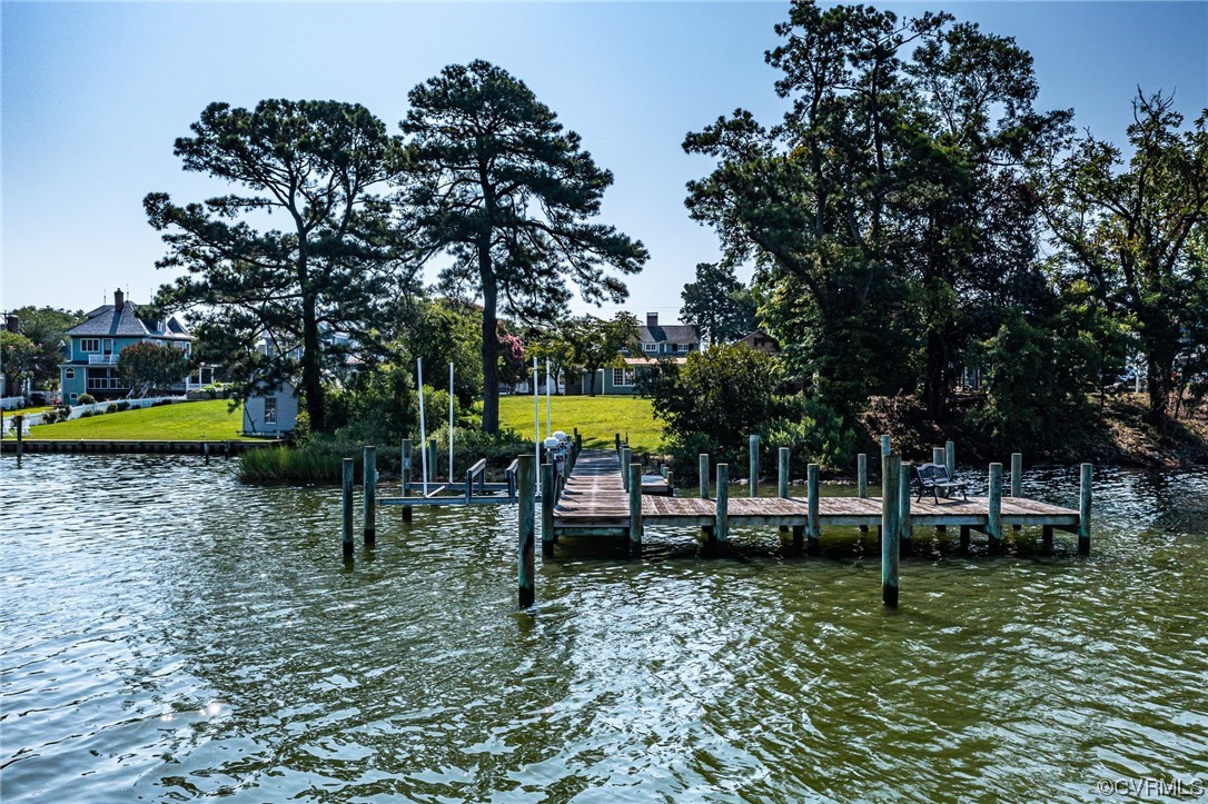 616 Main Street Reedville, VA 22539 - Photo 8 of 30 a view of a swimming pool with a bench and trees