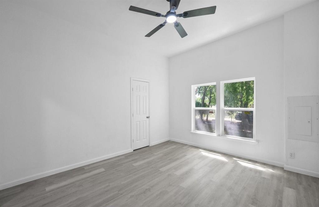 200 Austin Street Rice, TX 75155 - Photo 14 of 22 a view of an empty room with a window and wooden floor