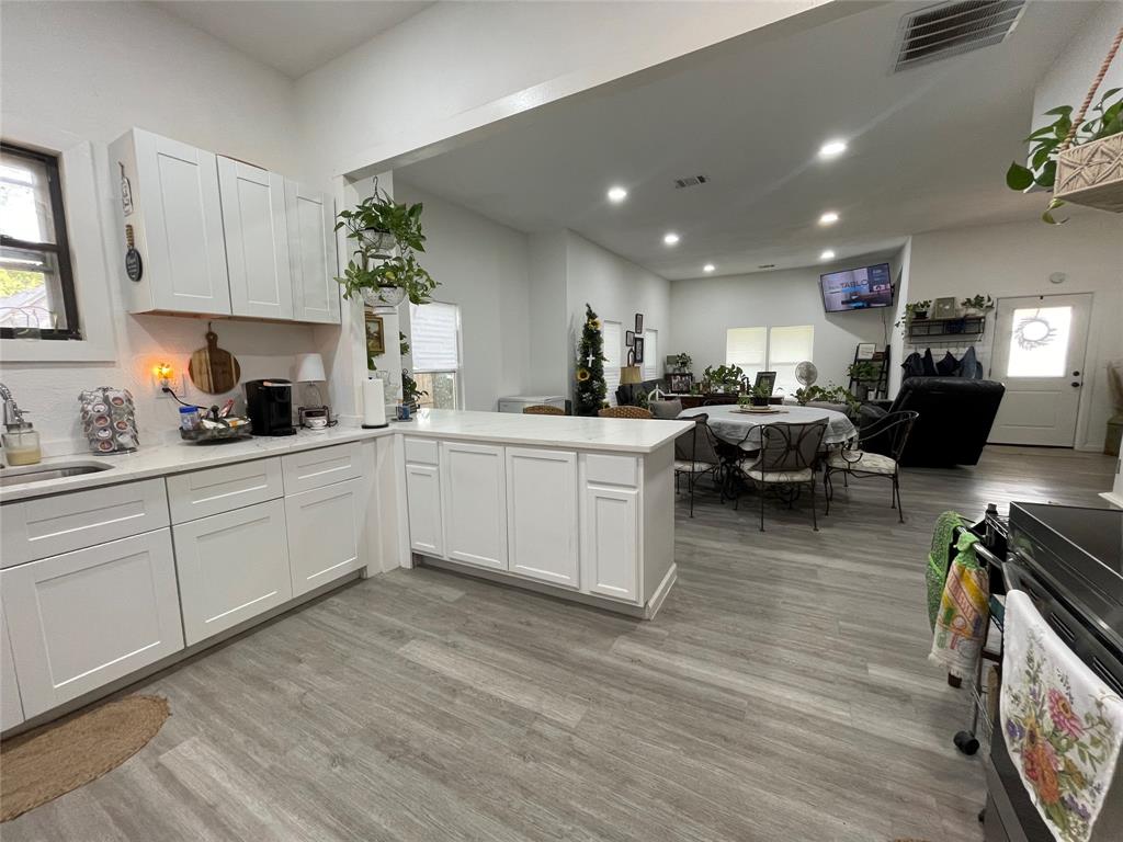 200 Austin Street Rice, TX 75155 - Photo 3 of 22 a kitchen with a sink stainless steel appliances and cabinets