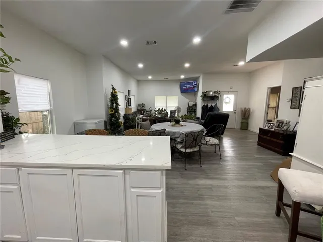 a large white kitchen with lots of counter space
