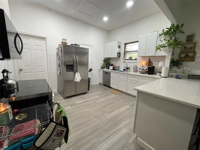 a kitchen with a sink appliances and cabinets