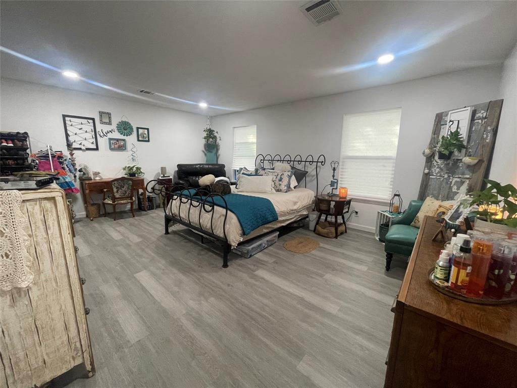 200 Austin Street Rice, TX 75155 - Photo 9 of 22 a bedroom with furniture and a wooden floor